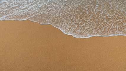 Soft sea wave on the sandy beach, natural background