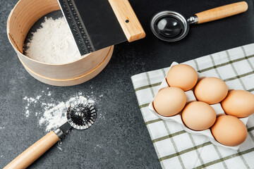 Preparing ingredients for baking with flour, eggs, and tools on the countertop