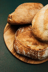 Freshly baked artisan bread on wooden serving board close-up view