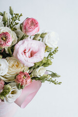 Beautiful bouquet of pastel flowers in soft colors on a light background