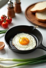 Cooking a sunny-side-up egg in a cast iron skillet with fresh ingredients on a kitchen counter