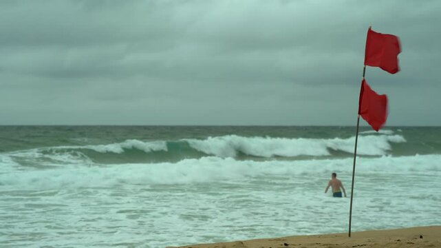 Amid red flags, a man went swimming in a dangerous ocean with big waves