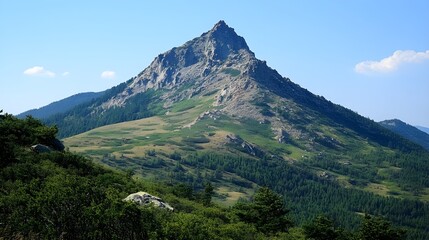 Naklejka premium Rising above the trees a majestic mountain peak stands tall whispering tales of nature s beauty and challenging climbs