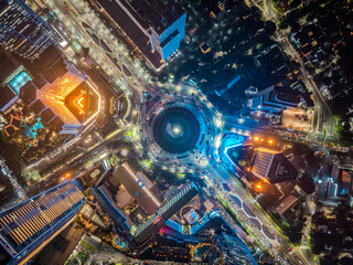 Night aerial view of skyscrapers and multi lane highway in large urban city center Cityscape of...