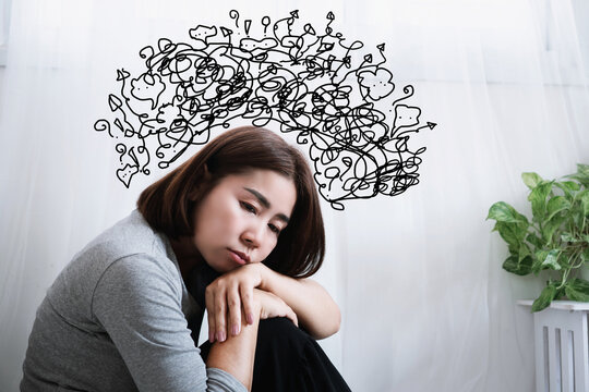 depressed asian woman suffering from anxiety, depression, and overthinking, filled with negative thoughts in mind, signs of mental health issues