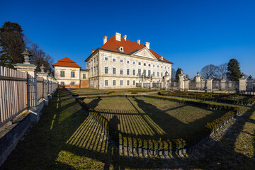Dornava Mansion casting long shadows in the formal garden in Slovenia