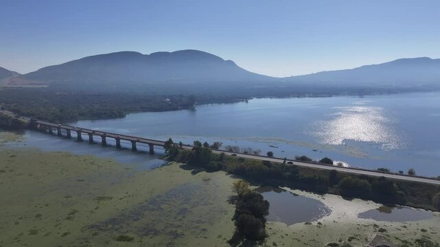 Hartbeespoort Bridge In Hartbeespoort North West South Africa. Elevated Road Bridge Symbol Of The City Viewed From Above. Countryside Dramatic Clouds Rural Field. Countryside Panning Wide.