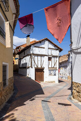 Medieval decorations hanging over narrow street in Canete, Spain © Richard Semik