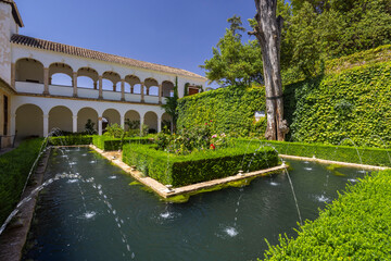 Fototapeta premium Fountains and gardens decorating the Patio de la Acequia in the Generalife Palace, Granada, Spain