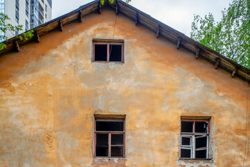 A fragment of the facade of an abandoned building on a spring day