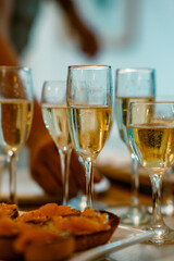 Let the celebration begin! Gleaming flutes of sparkling wine stand ready alongside a platter of appetizers, promising a joyful and festive occasion filled with cheer.