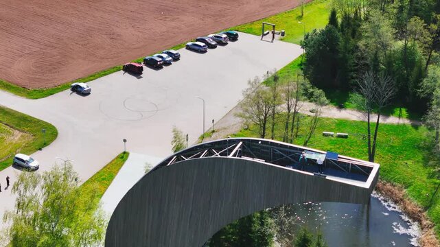 Flying Above Kirkilai Observation Tower - View Tower Resembling A Canoe Overlooking Pond And Fields In Birzai, Lithuania. drone shot