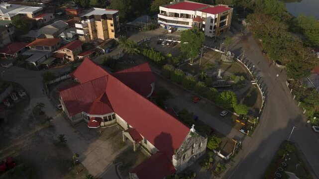 Aerial rising and tilt down to show the t-shaped roof of St. Francis of Assisi church in Siquijor.