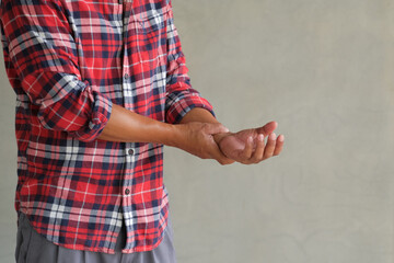 Asian man stands with severe arm pain, an emergency bone disease requiring hospitalization. Woman holding arm and Severe arm pain. Arm injury