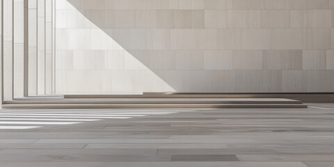 Bright sunlight casts shadows over minimalist architecture in a spacious interior during daytime