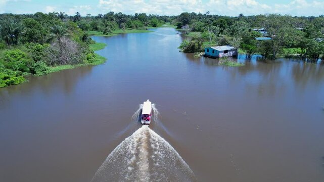 Boat Sailing In Manaus Amazonas Brazil. Boat Sailing With Tourists Enjoying The Trip In A Sunny Day. Travel Environment Wilderness Jungle. Wilderness Amazon Rainy Season. Manaus Amazonas.