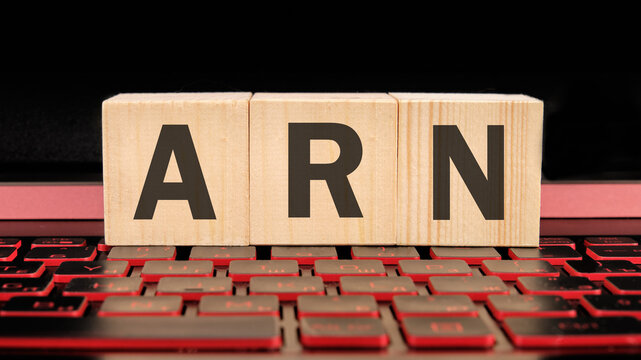 ARN as Account Reference Number written on wooden cubes on the laptop keyboard