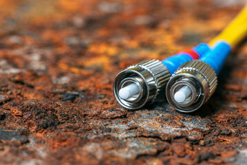 Fiber optic patch cords in telecommunication optical network on rusted corroded metal background
