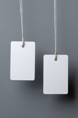 Two blank price tags hanging from strings