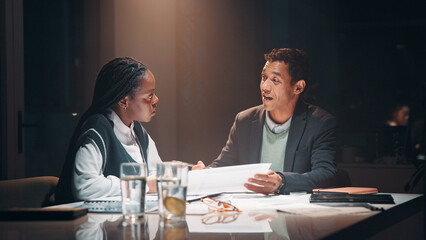 Feedback, paperwork and business people at night meeting for overtime, planning or research. Creative startup, collaboration and man and woman working on project, proposal and brainstorming in office