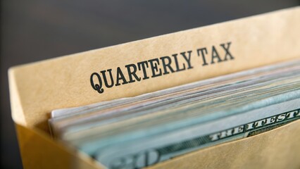 Citizen Tax Responsibility concept. Quarterly tax documents in a file folder with cash peeking out.