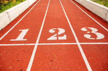 Red running track in stadium. Sport recreation