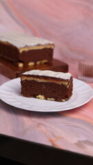 Kaasstengels or often called Cheese Shortbread in the photo with a wooden coaster and white plate. Cheese Shortbread pieces in the photo with a close up and a 45 degree angle