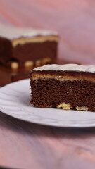 Kaasstengels or often called Cheese Shortbread in the photo with a wooden coaster and white plate. Cheese Shortbread pieces in the photo with a close up and a 45 degree angle