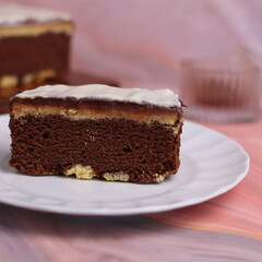 Kaasstengels or often called Cheese Shortbread in the photo with a wooden coaster and white plate. Cheese Shortbread pieces in the photo with a close up and a 45 degree angle
