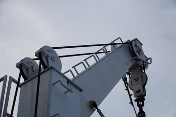 Close-Up View Of A Crane's Rigging And Mechanics Against A Cloudy Sky