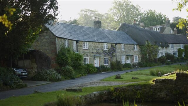 A small town with a stone house and a few other houses. The houses are
