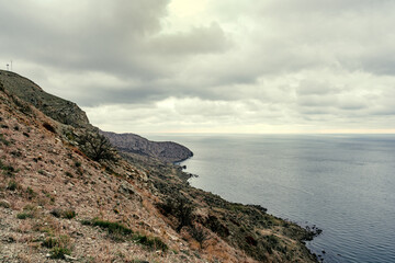 Scenic coastline view with rocky cliffs and cloudy skies at a coastal location