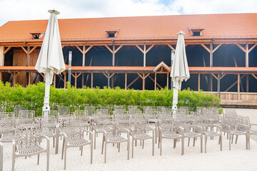 Empty Outdoor Seating in Front of Rustic Wooden Barn