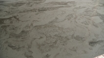 Self-leveling concrete floor screed pouring, surface smoothing with mixture distribution