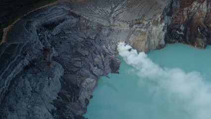 aerial view of the interior of a volcano crater, with a lake of sulphur. Java, Indonesia - 19th March 2025