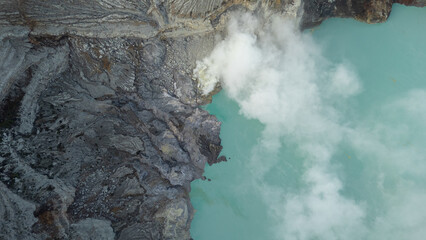aerial view of the interior of a volcano crater, with a lake of sulphur. Java, Indonesia - 19th March 2025