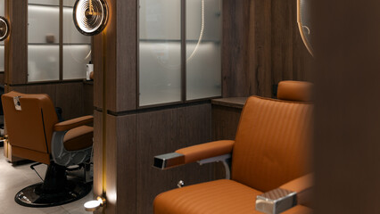 Modern barber shop interior with brown leather chairs and sleek wooden design