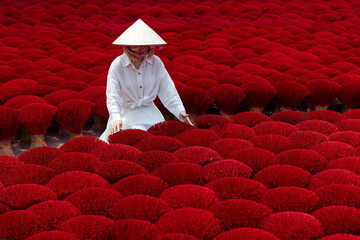 Female worker among incense sticks in Vietnam, Quang Phu Cau handicraft village