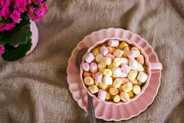 Cozy Morning with Coffee and a Book. A warm cup of coffee, a book, and sweet marshmallows perfect for a relaxing moment