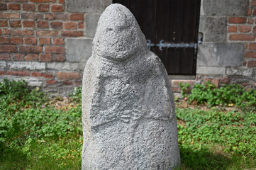 Ancient stone carving and green grass