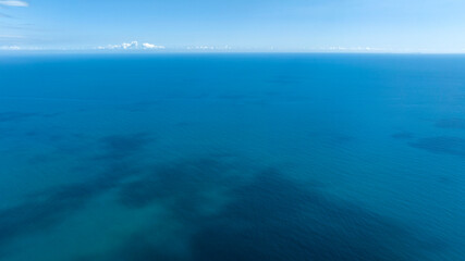 Obraz premium Aerial view of the blue sea. The surface of the water is calm and clean. There are no boats until the horizon.