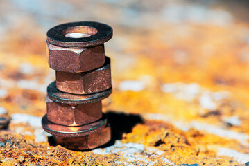 Nuts and washers on a corroded steel surface, close-up view