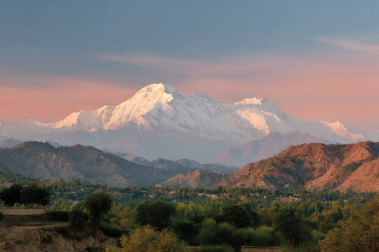 breathtaking view of nanga parbat peak at sunset with sky painted in warm hues of orange and purple
