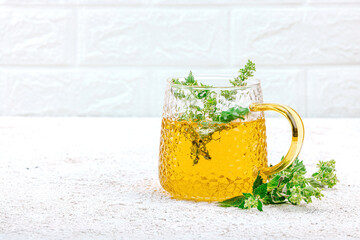 Lemon balm tea on white background. Fresh edible herbs, trendy drink. Organic healthcare