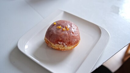 Tasty Sweet Donut with Sugar Icing Frostling on Porcelain Plate