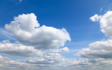 Fototapeta premium A beautiful blue sky with soft, white clouds, for an abstract background