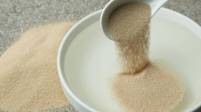 The process of pouring dry active yeast into warm water: slow motion cooking.