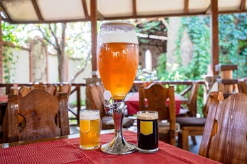 View on glass beer tower with glass of beer at the pub