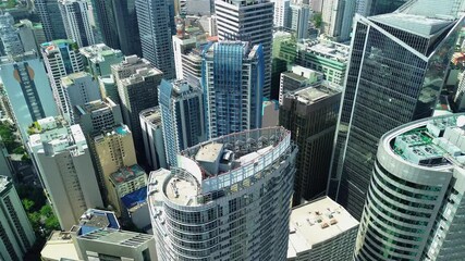 Drone glides above the skyline of Makati in Manila, showcasing modern skyscrapers and dense urban architecture from a high perspective. - Powered by Adobe