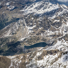 aerial landscape with Trona dam and reservoir on norhern side of Tre Signori mountain range, near Gerola Alta, Italy